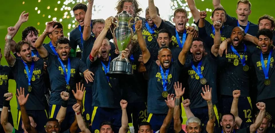 Team celebrating championship victory with trophy