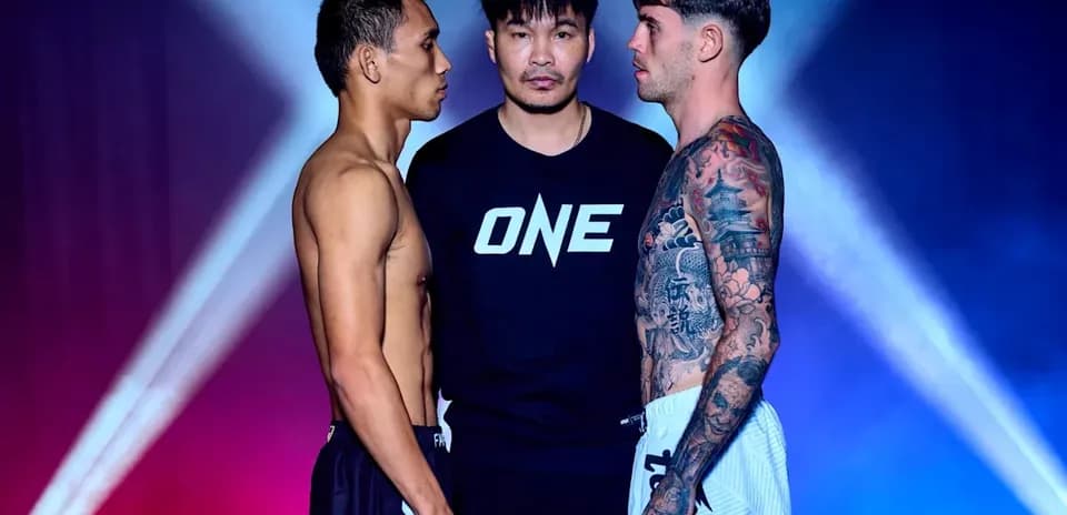 Two fighters facing off with a referee between them