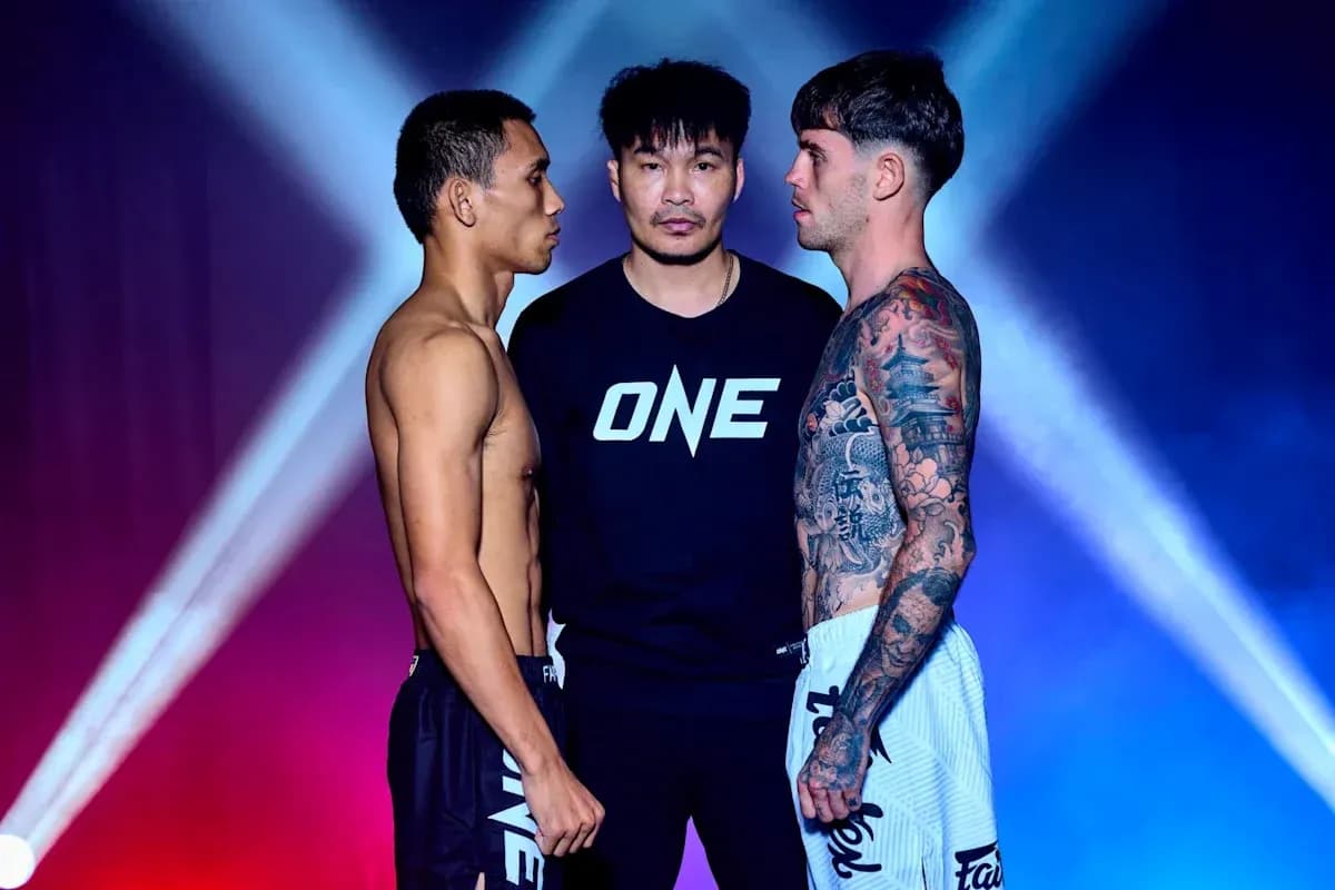 Two fighters facing off with a referee between them