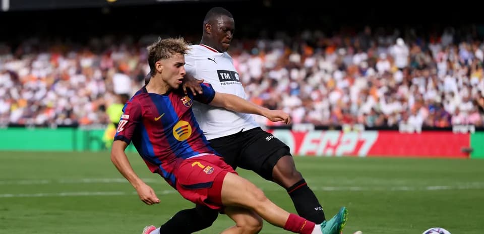 Barcelona player tackling opponent during match action