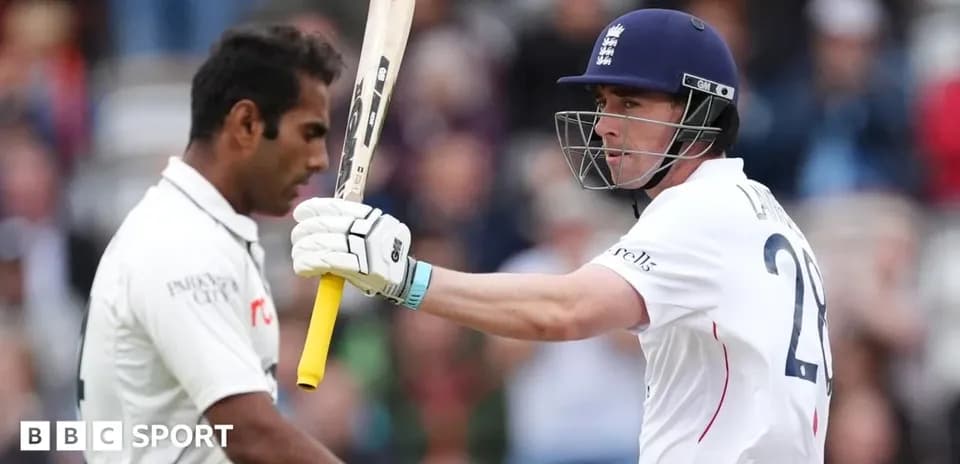Batsman celebrating while bowler looks on during match