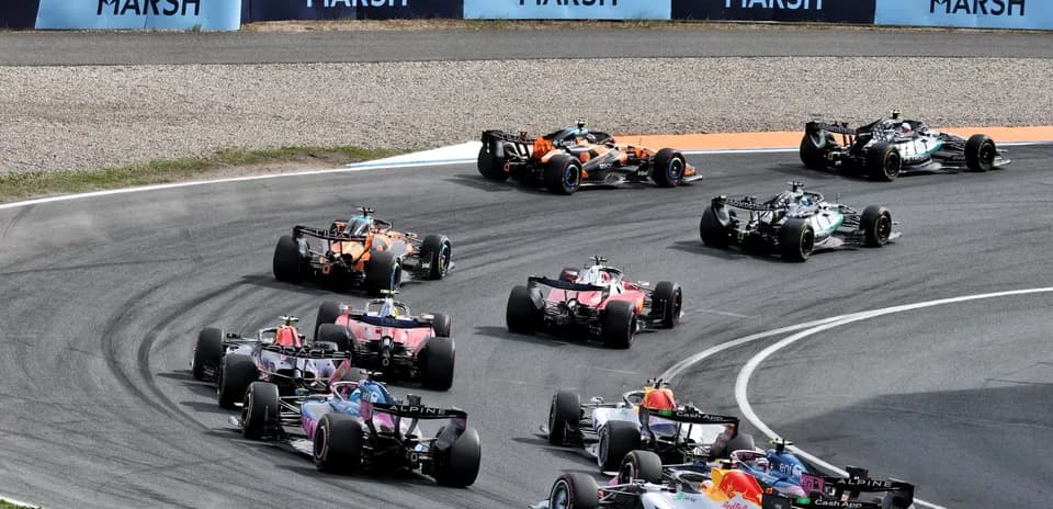 Formula 1 cars racing through a tight corner