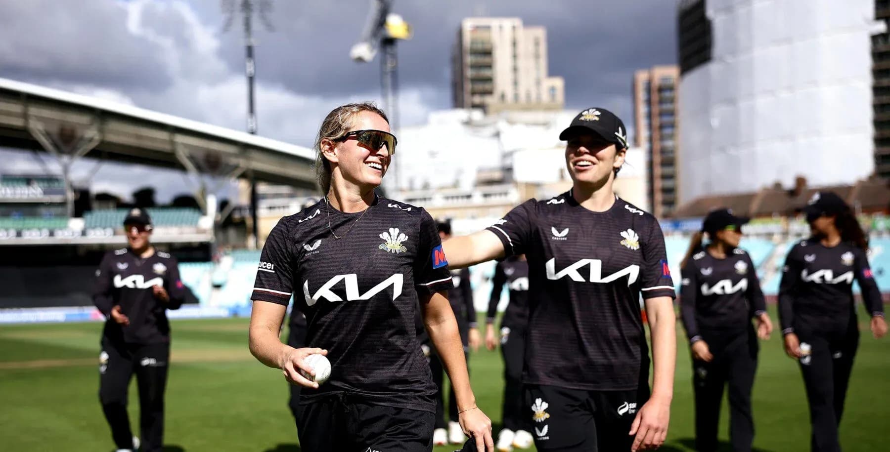 Two cricketers celebrating after a match at the stadium