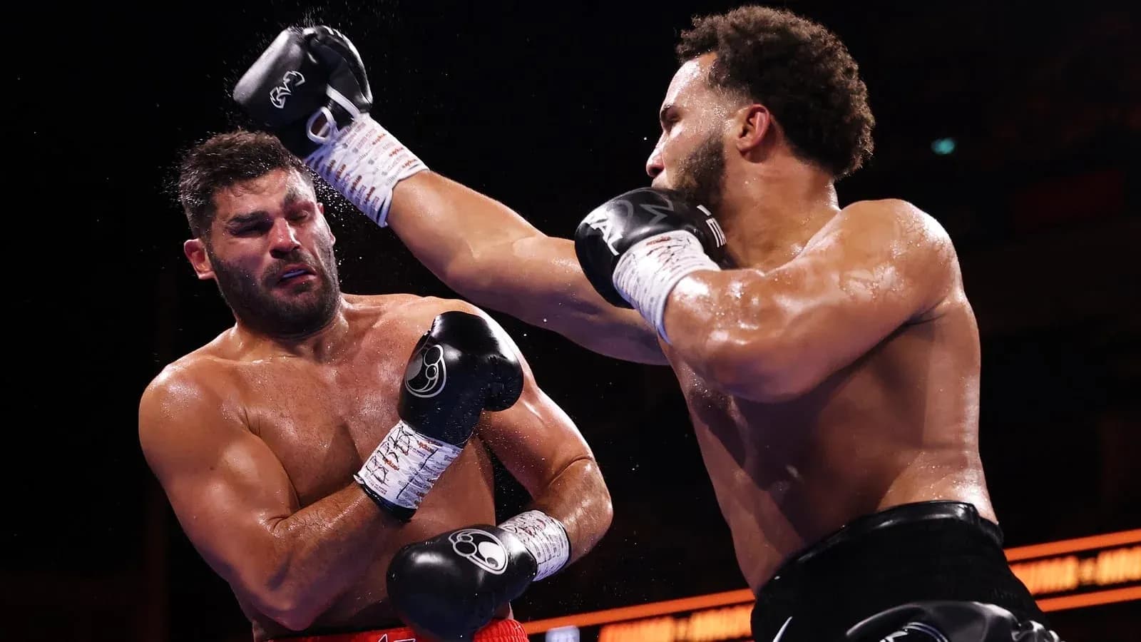 Two boxers exchanging punches in the ring