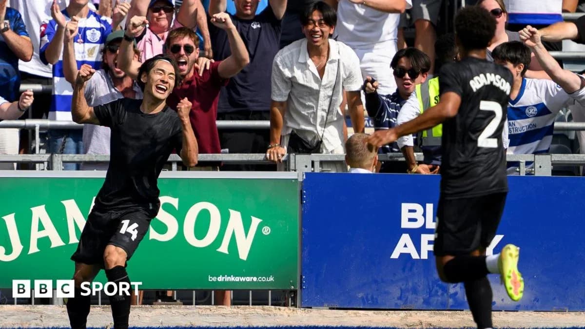 Player celebrating goal with fans in background