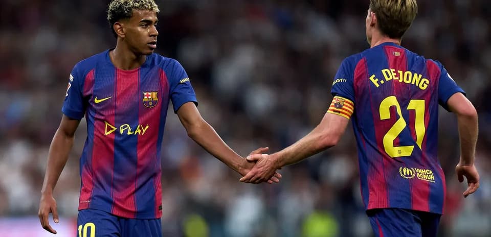Two FC Barcelona players exchanging a handshake