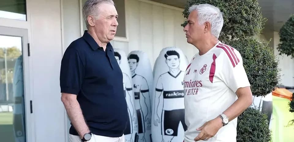 Two coaches talking near training equipment