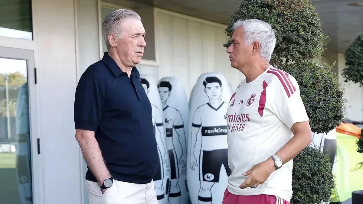 Two coaches talking near training equipment
