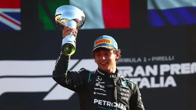 Driver celebrating with trophy after race victory