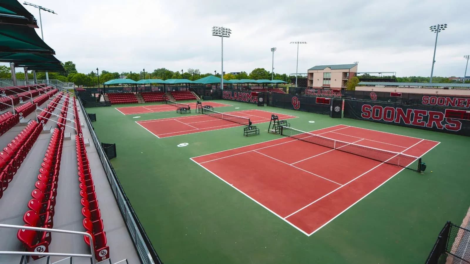 Tennis courts at Oklahoma University with empty bleachers