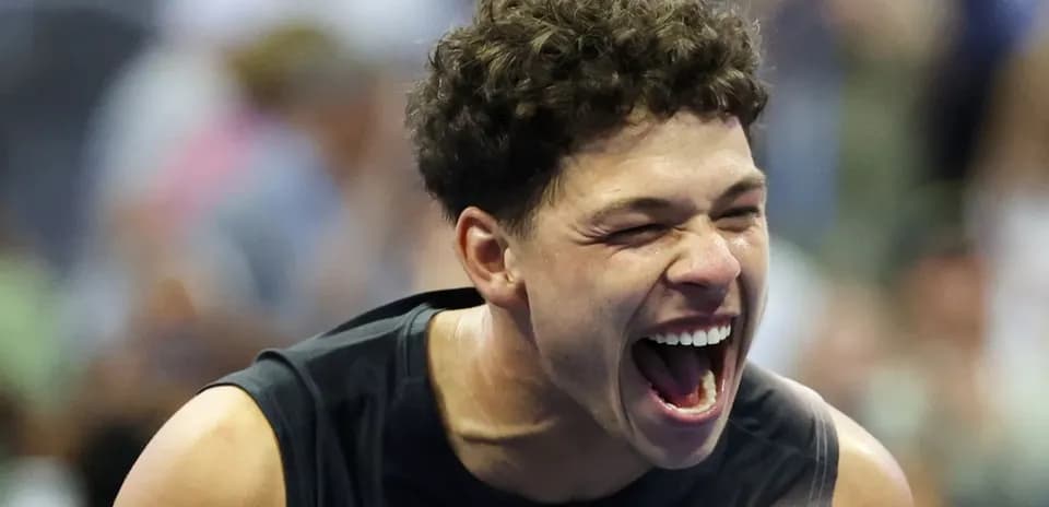Player celebrating with a big smile on court