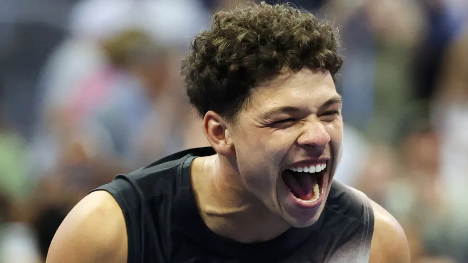 Player celebrating with a big smile on court
