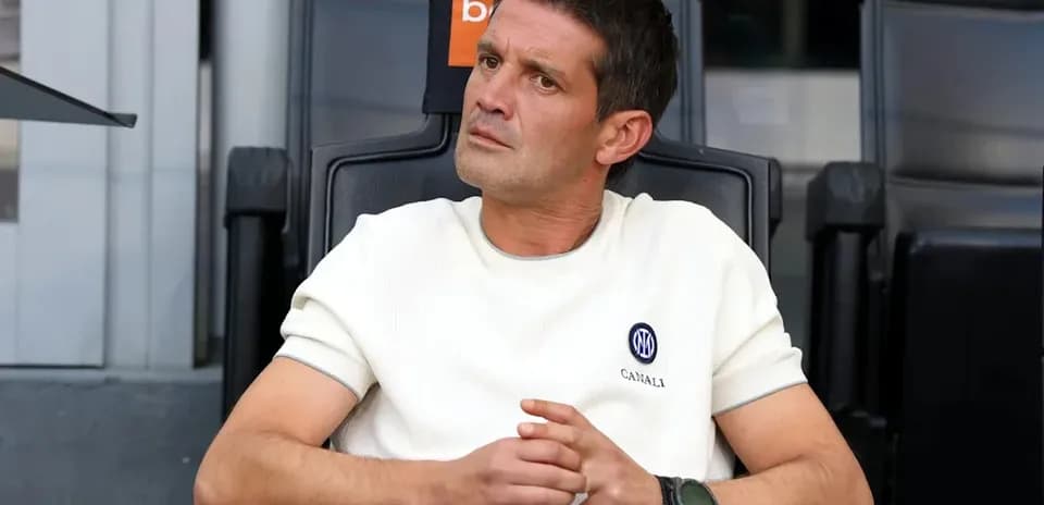 Coach seated on the bench during a match