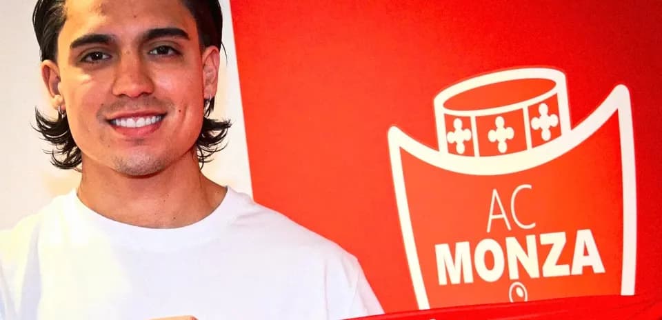 Player holding AC Monza scarf in front of logo