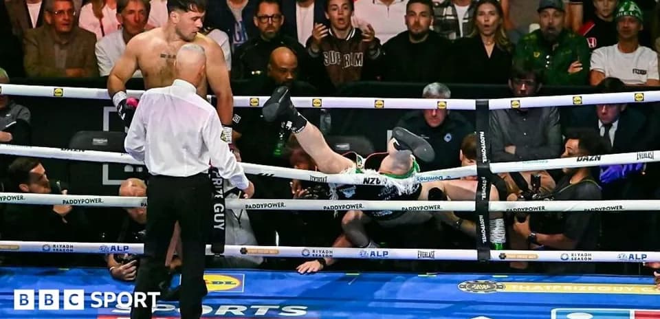 Boxer knocked out, falling through the ropes