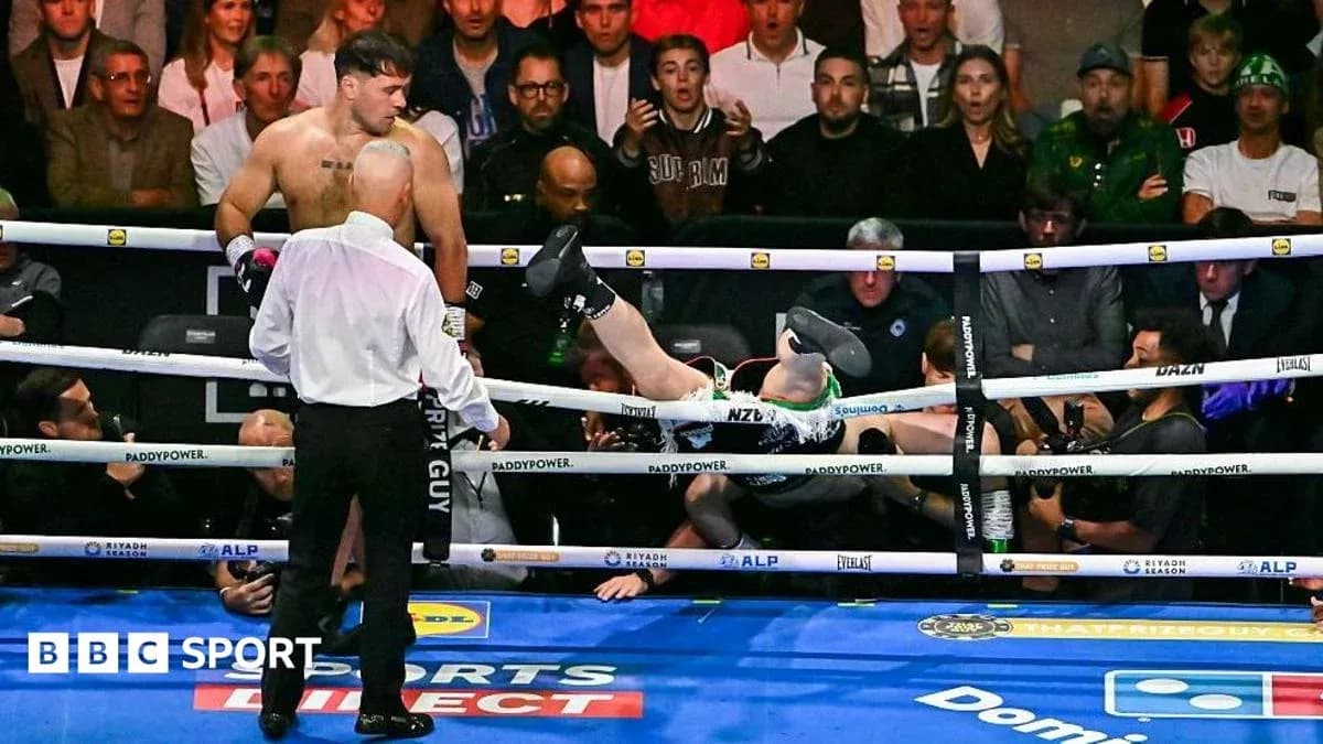 Boxer knocked out, falling through the ropes