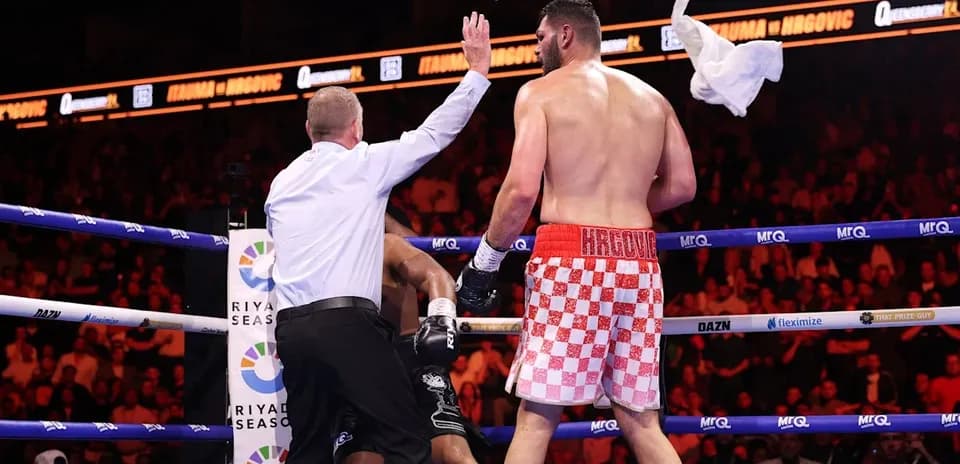 Referee stopping the boxing match with a towel
