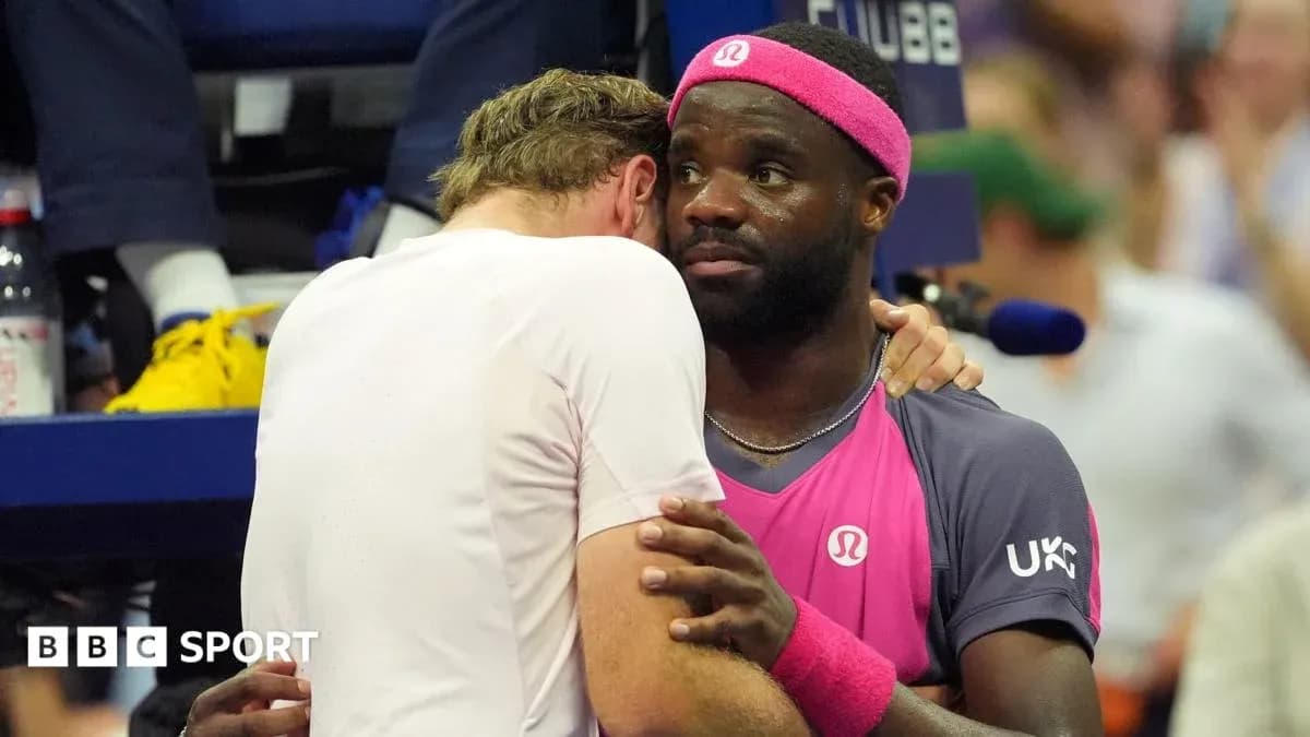 Two tennis players embracing during a match