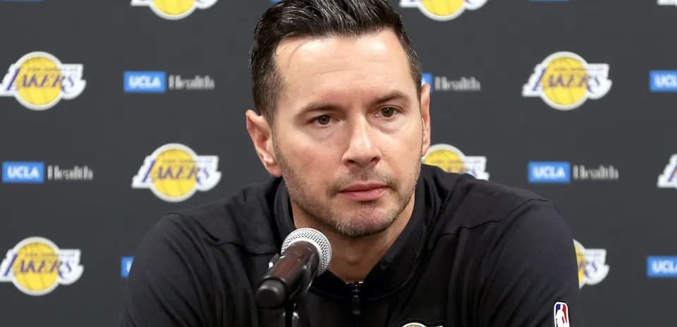 Lakers coach speaking at press conference podium