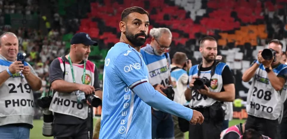 Player walking past photographers after match
