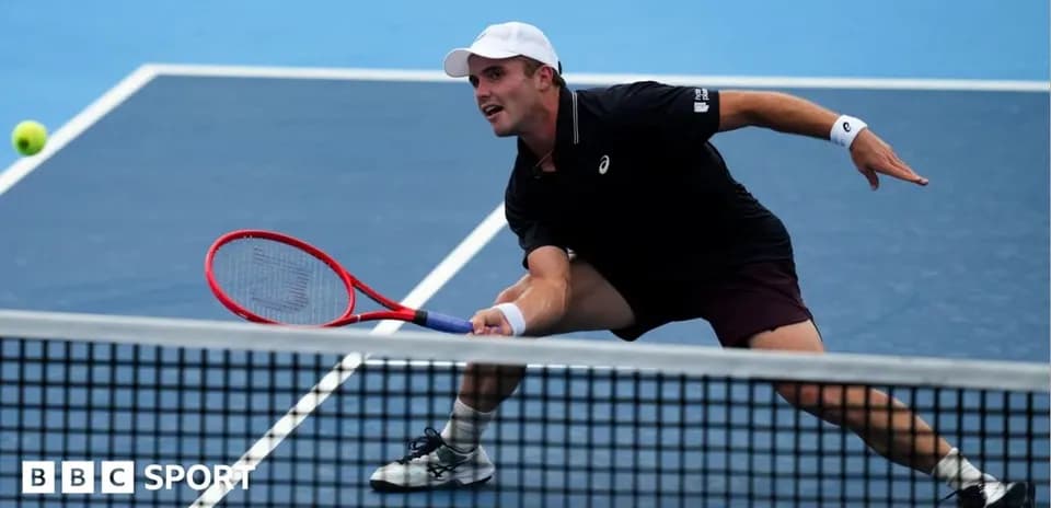 Player lunging to hit a tennis ball during match