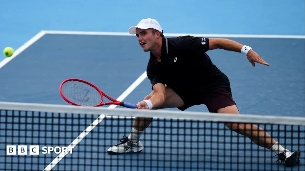Player lunging to hit a tennis ball during match