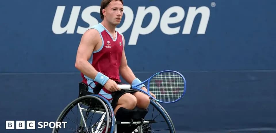 Wheelchair tennis player preparing to serve at US Open