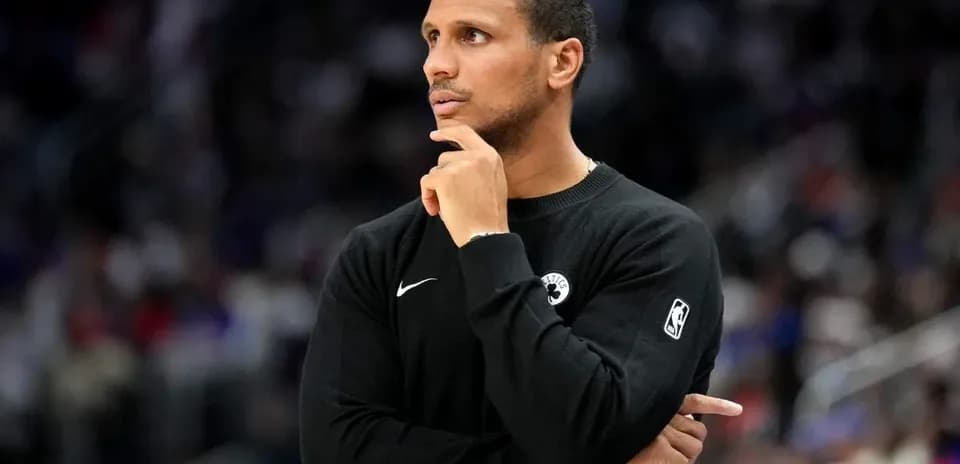 Coach observing game with hand on chin