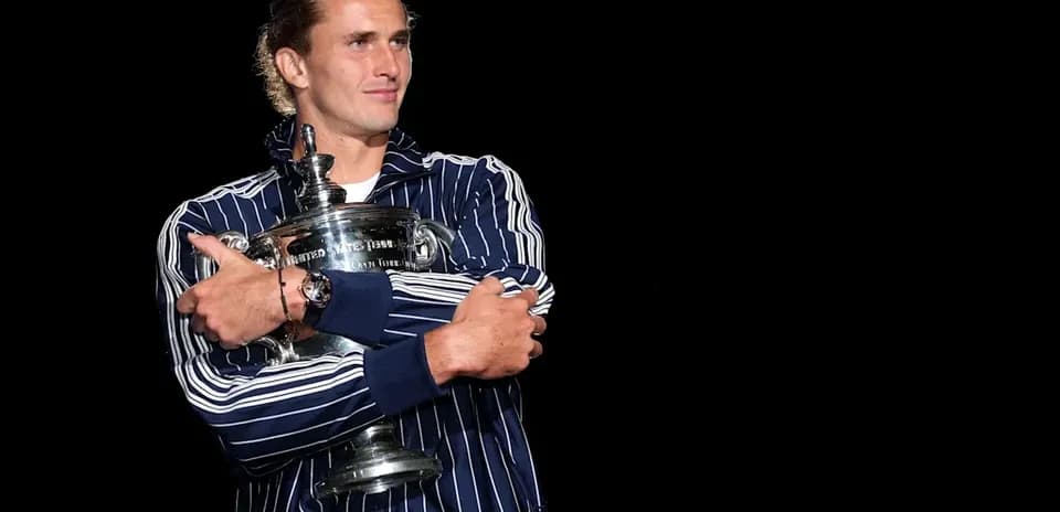 Player holding trophy on stage after victory