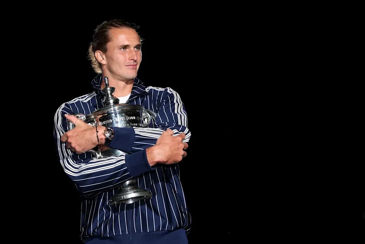 Player holding trophy on stage after victory