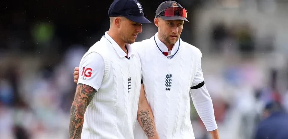 Two cricketers walking off the field in whites