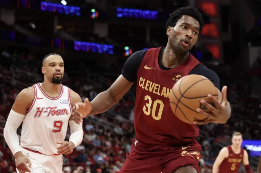 Cleveland player dribbling basketball against defender