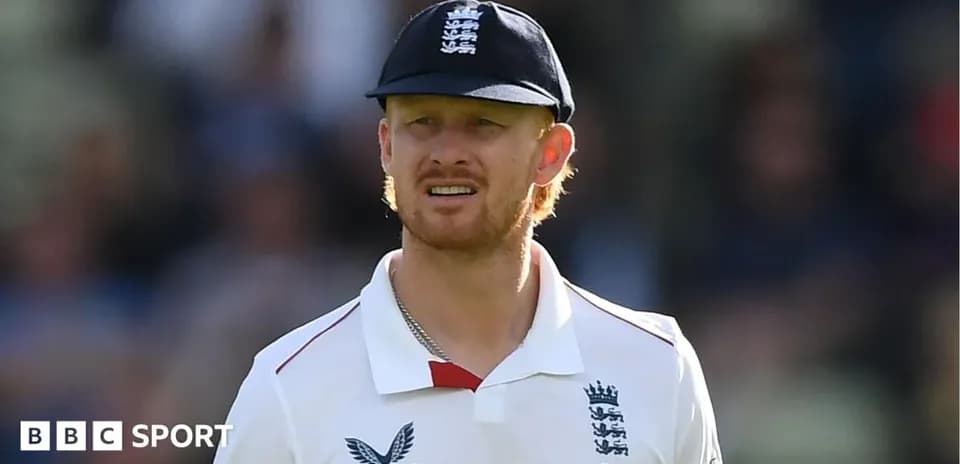 Cricketer wearing England kit on the field
