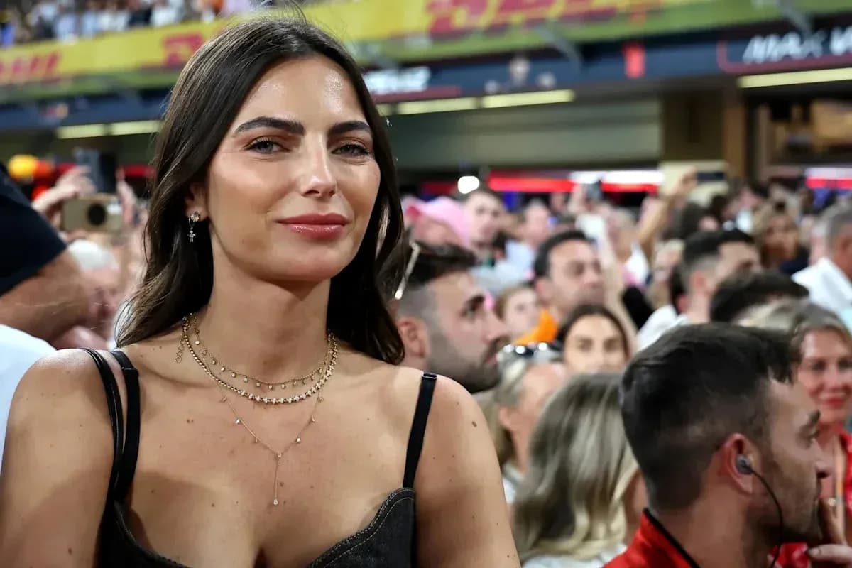 Woman smiling in a crowded stadium during event