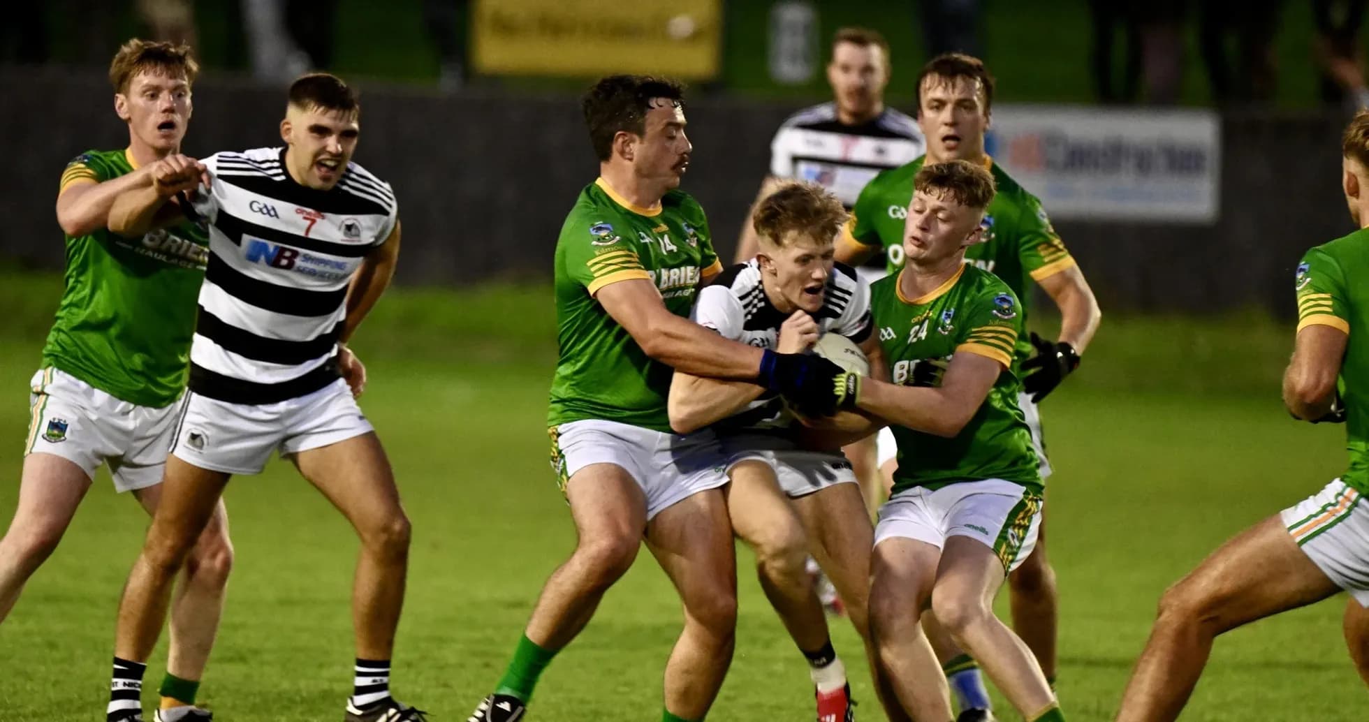 Players in a tackle during a Gaelic football match
