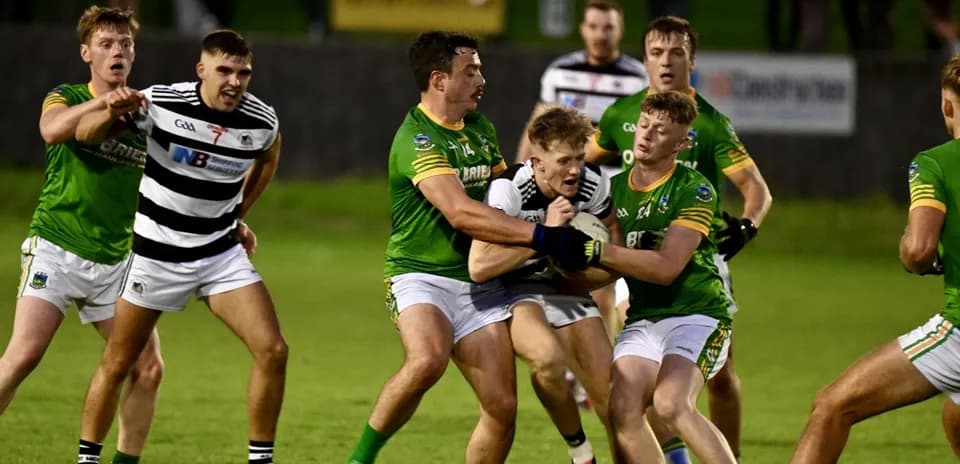 Players in a tackle during a Gaelic football match