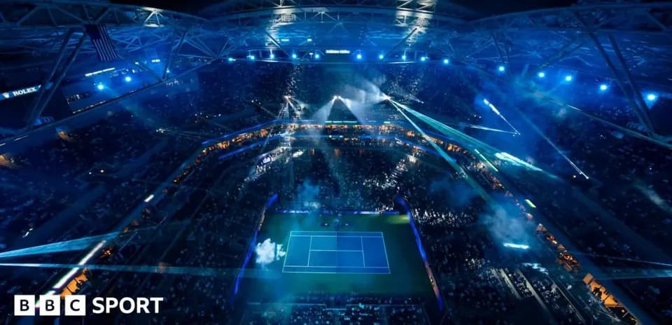 Aerial view of a tennis match in stadium at night