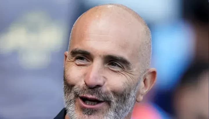 Coach smiling during a match day event