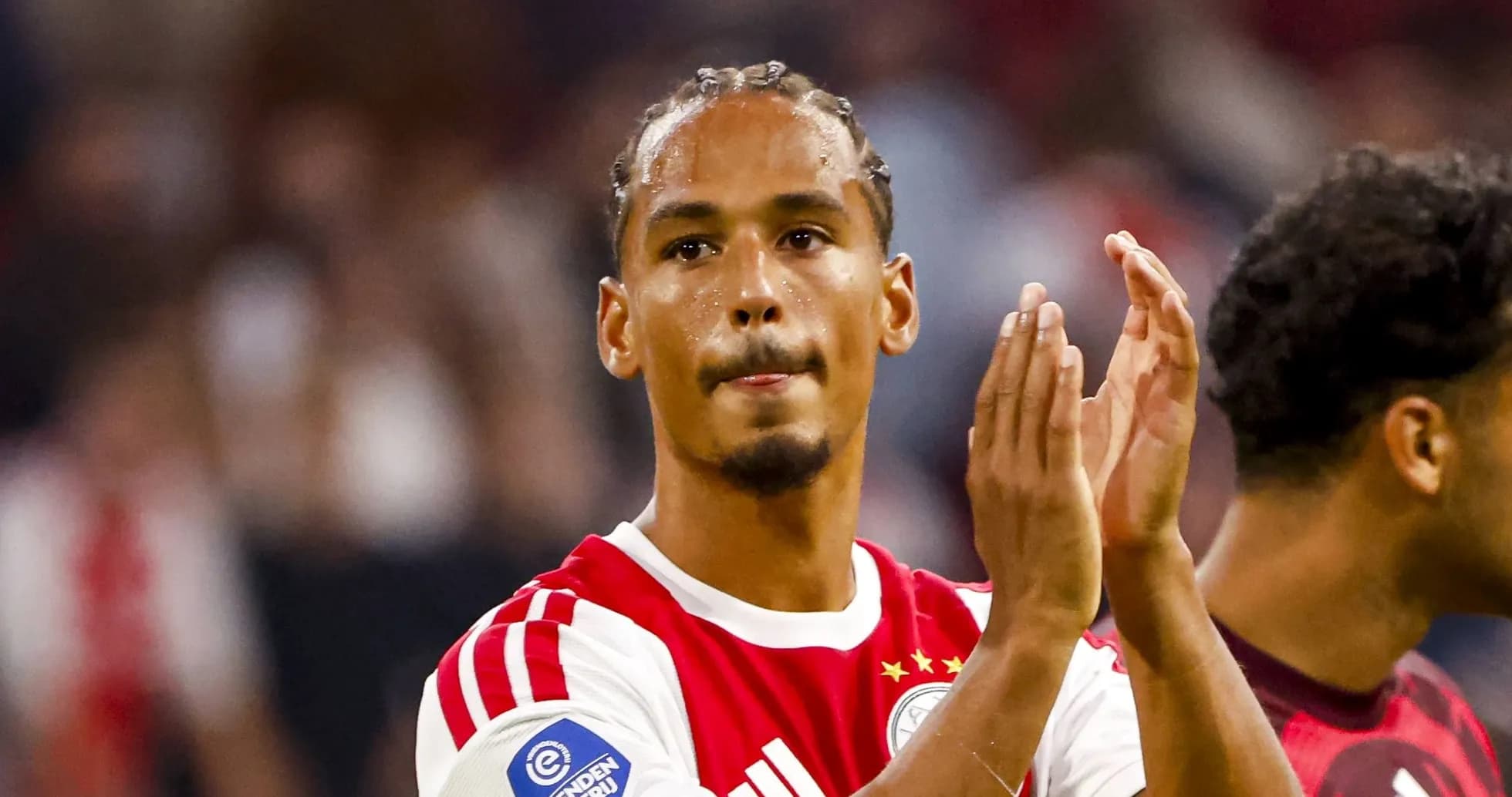 Player applauding fans after match in stadium
