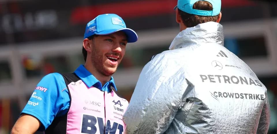 Two drivers conversing in paddock area during event
