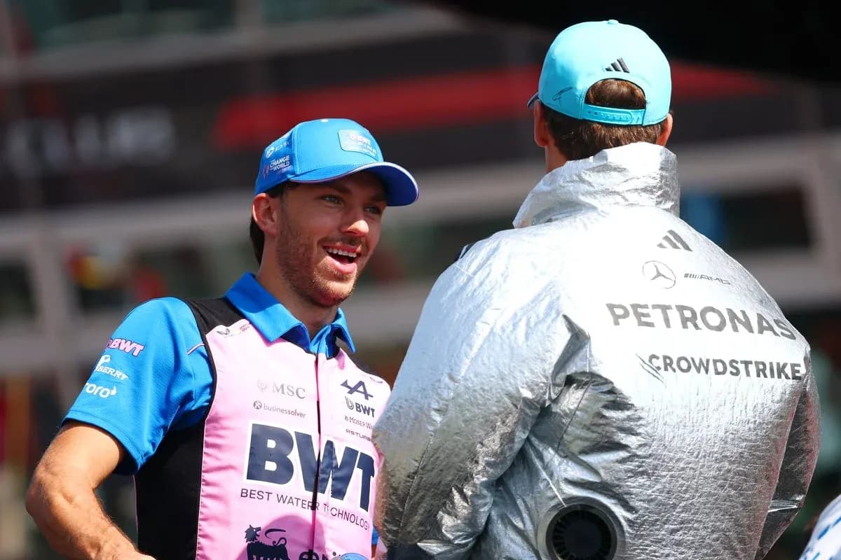 Two drivers conversing in paddock area during event