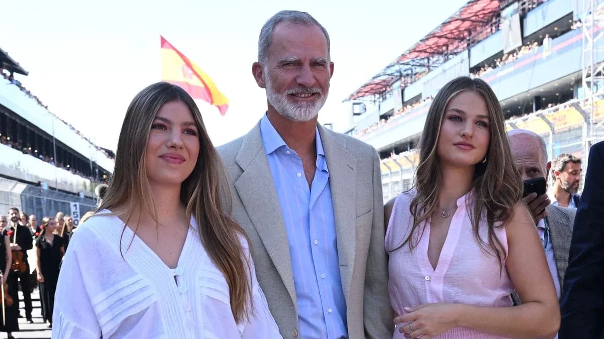 Three individuals posing at a racing event