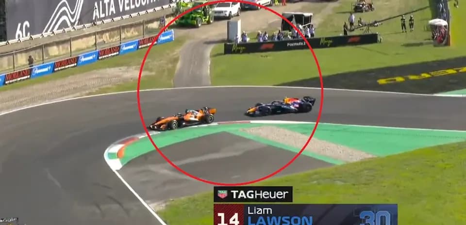 Two Formula 1 cars racing on track corner