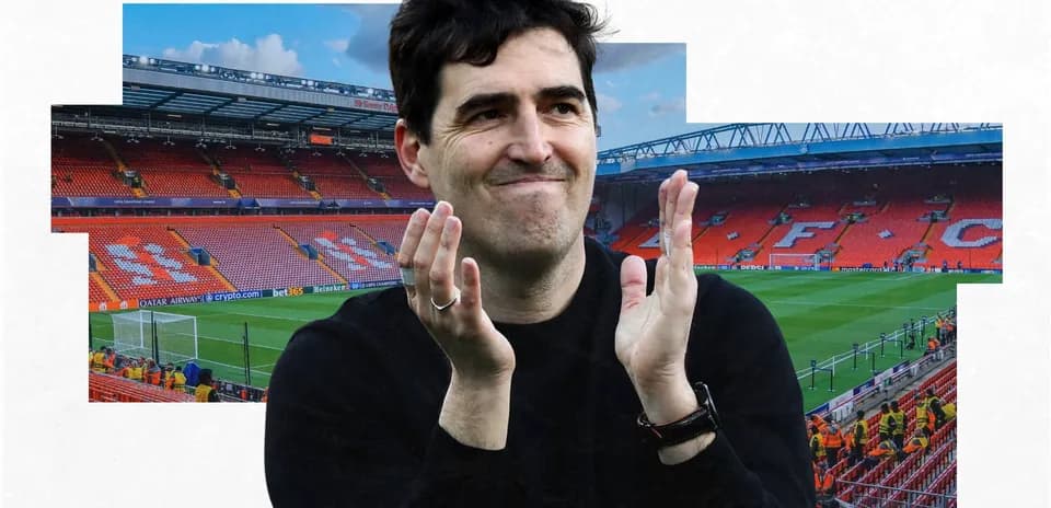 Man applauding in front of Anfield stadium seats