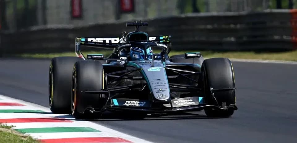 Formula 1 car racing on track with colorful curbs