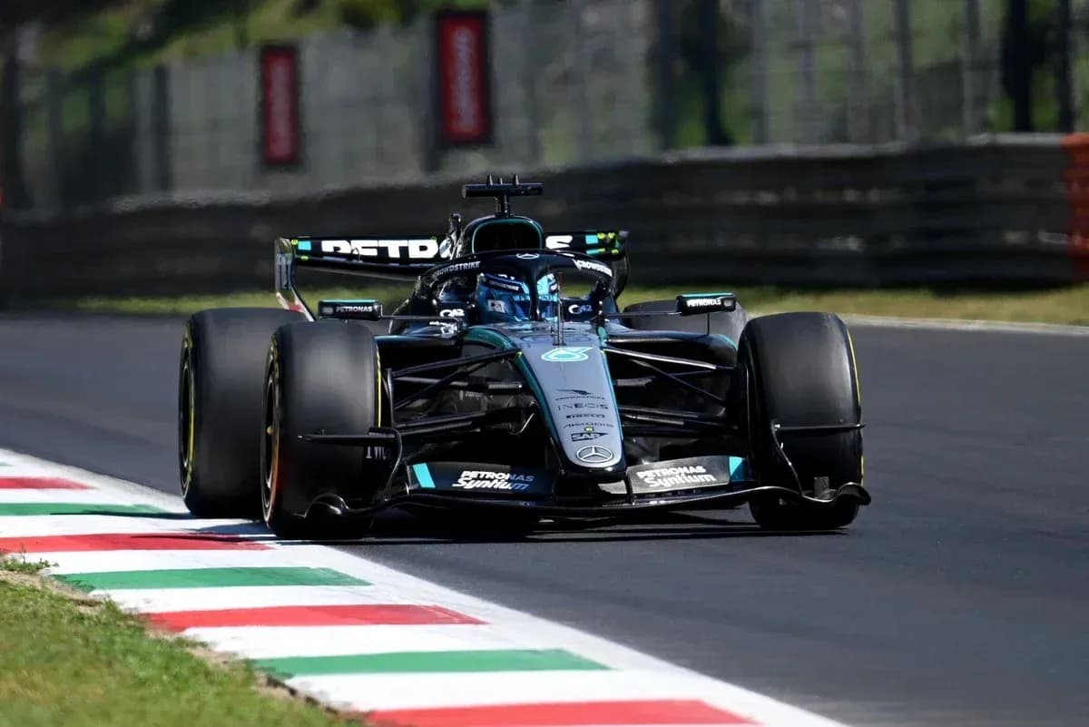 Formula 1 car racing on track with colorful curbs