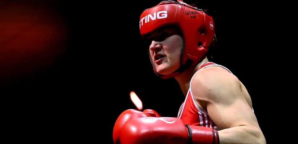 Boxer in red gear preparing for match