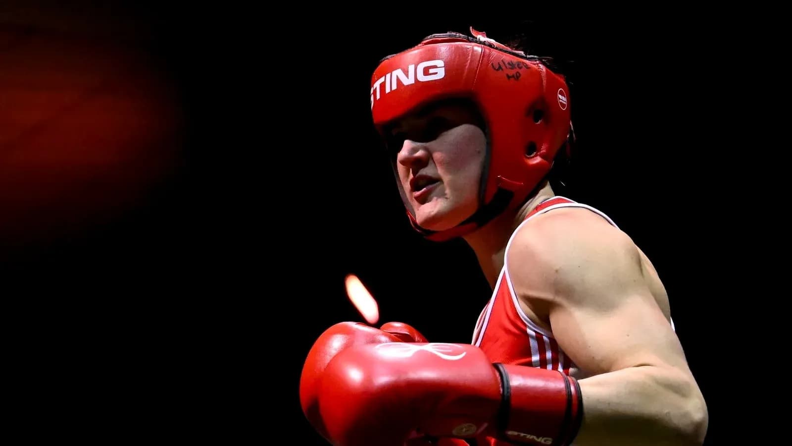 Boxer in red gear preparing for match