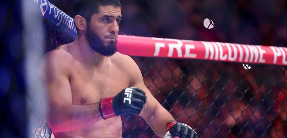 Fighter sitting in corner of UFC octagon