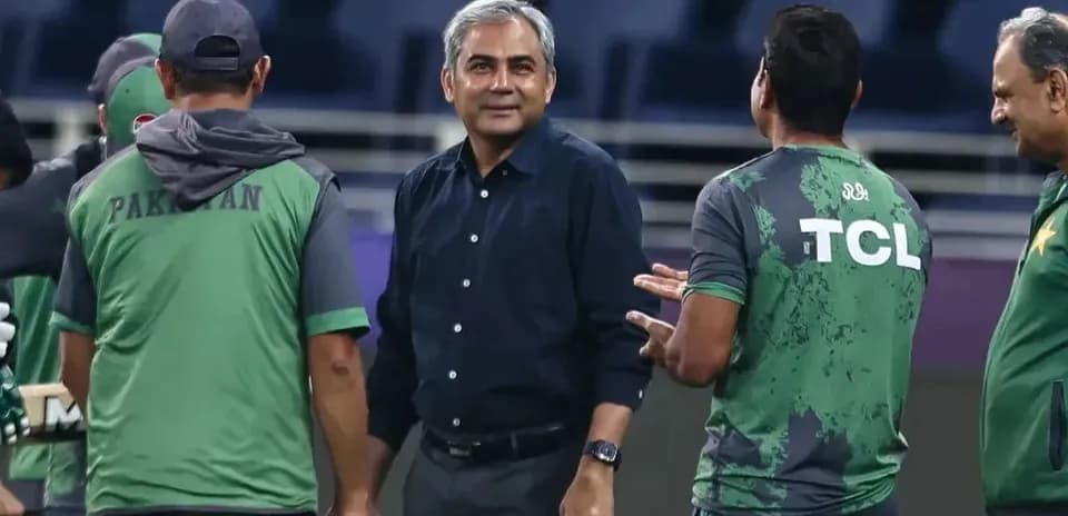 Coaching staff discussing strategies during practice session